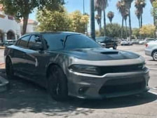 Picture of a grey Dodge Charger after being washed and waxed. The car is parked on an outside concrete floor in a car park. This picture was taken in Woodland Hills, Ca